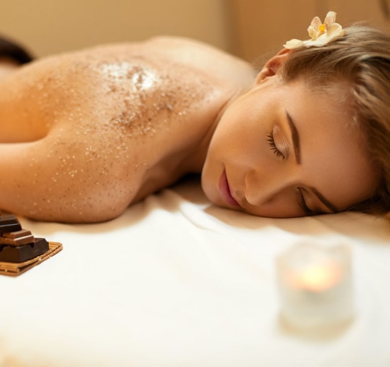 Woman getting massage with brown crystals