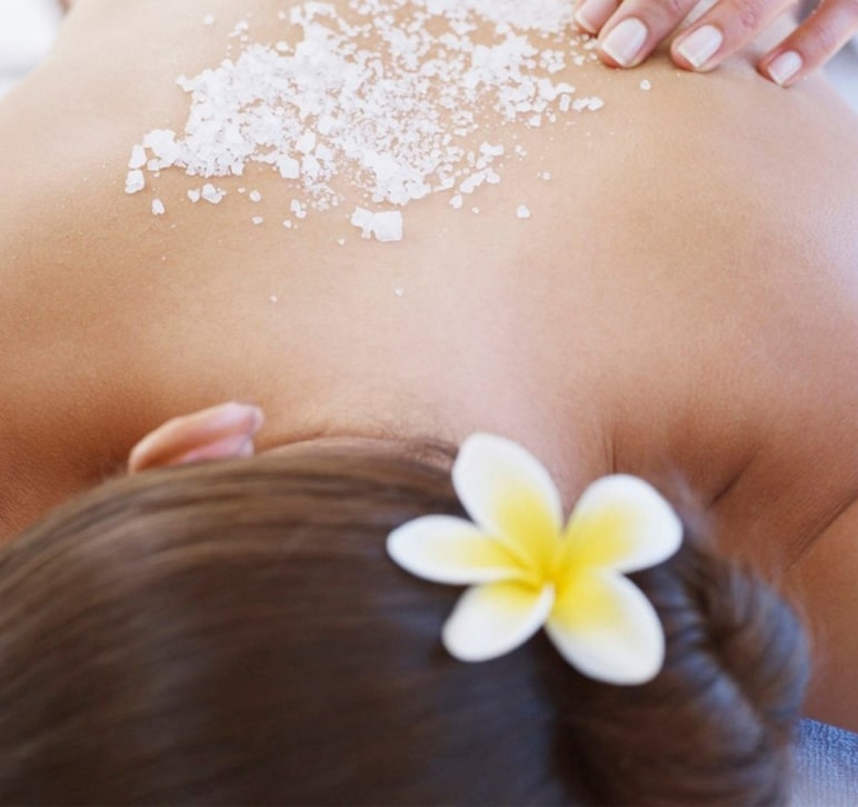 Woman getting massage with crystallized salt